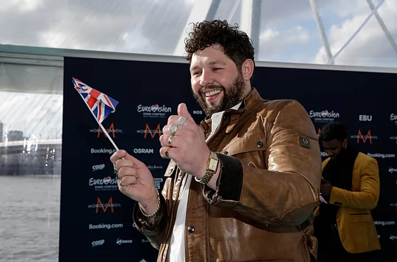  James Newman from the United Kingdom poses for photographers upon arrival at the Turquoise Carpet event of the Eurovision Song Contest, 2021.