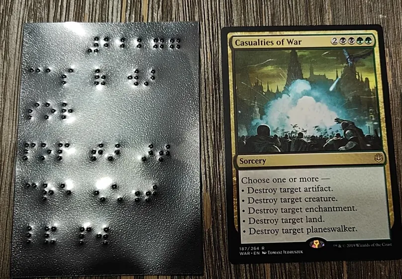 Image of a 'Magic: The Gathering' card on the right with its 'brailled' sleeve on the left