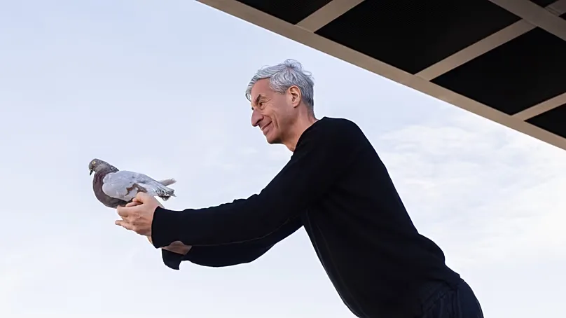 Maurizio Cattelan holds a taxidermied pigeon during the opening of his Night exhibition at Berlin’s Neue Nationalgalerie.