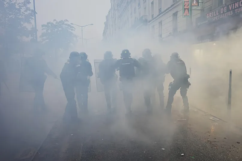 Police officers run toward protesters during a demonstration against rising living costs in Paris, Saturday, 24 Oct., 2026.
