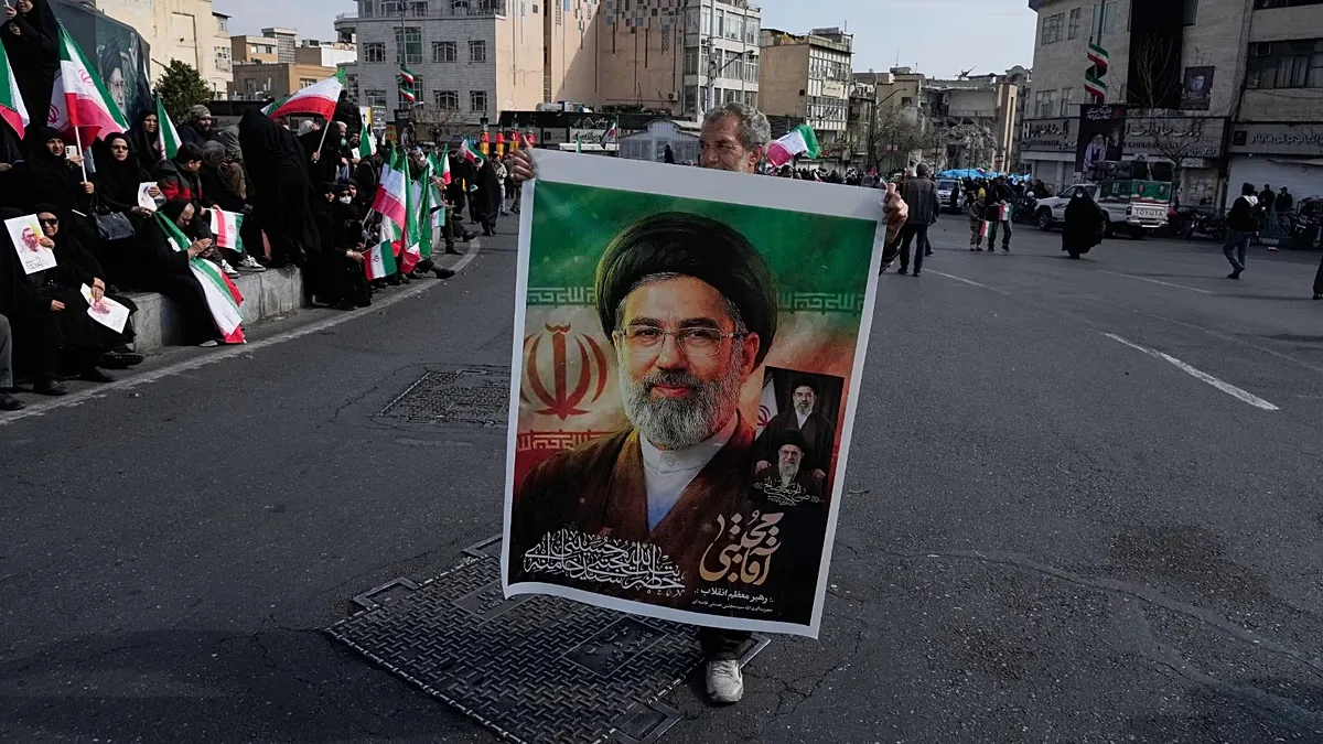 A photo of Mojtaba Khamenei held by a supporter of the Islamic Republic