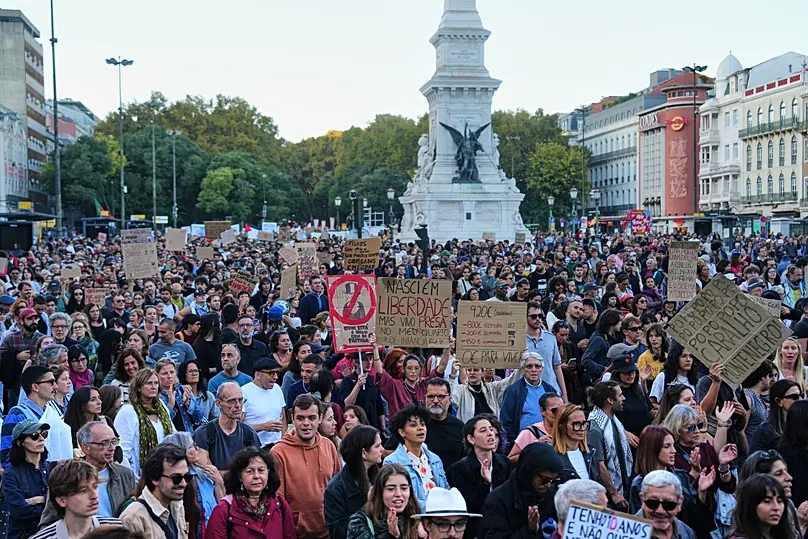 People march during a protest to demand affordable housing in Lisbon, Portugal, Saturday, Oct. 24, 2026. (AP Photo/Ana Brigida)