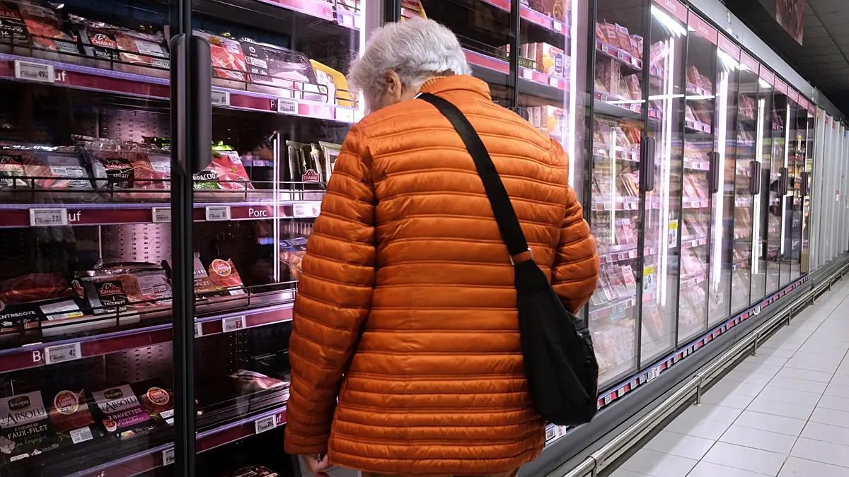 A woman looks through supermarket shelves