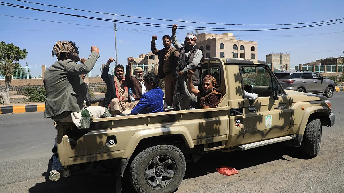 FILE: Houthi supporters chant slogans while riding in the back of a pickup truck at an armed tribal rally in Sanaa, 7 October 2026