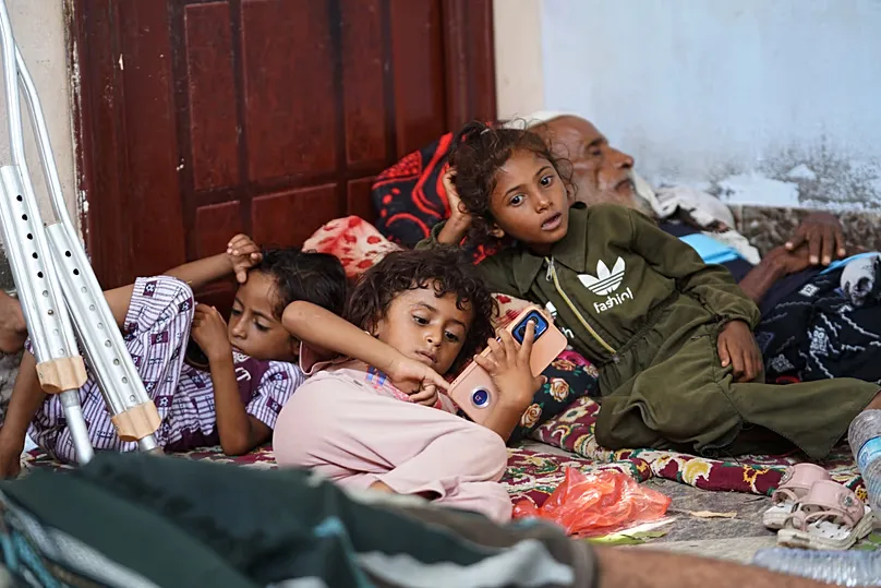 Displaced Yemenis rest at a temporary shelter in the Dar Saad district of Aden, 12 September 2026