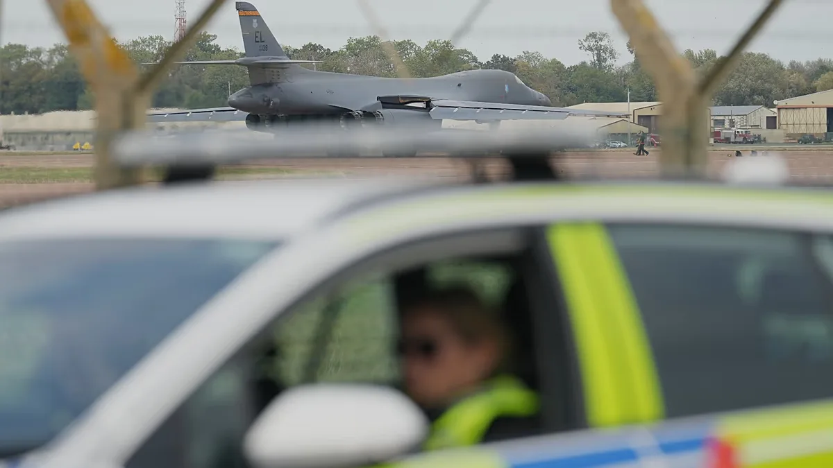 A B1 bomber prepares to take off as police officers man a checkpoint near RAF Fairford air base, in Fairford, England Tuesday, Sept. 29, 2026.