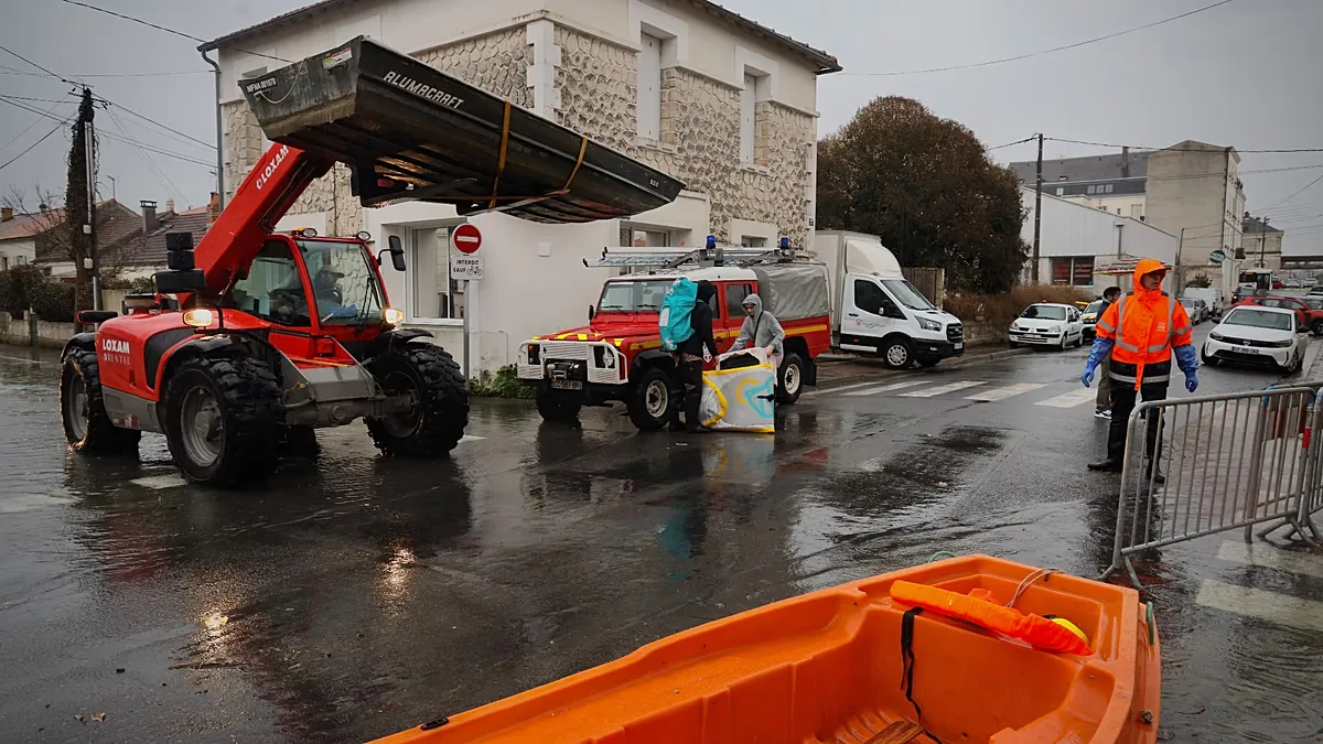 Emergency services operate near a flooded street in Saintes, as severe flooding hits western France due to Storm Pedro, on 18 February 2026