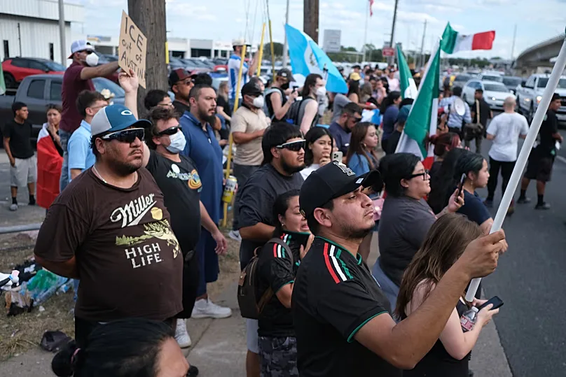 People protest at the site where local authorities say an ICE officer shot and wounded a man in Austin, 20 September, 2026