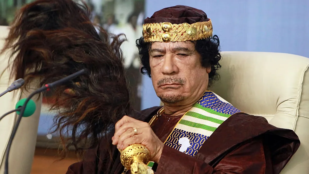 FILE: Libyan leader Moammar Gadhafi fans his face during the Forum of Kings, Princes, Sultans, Sheikhs and Mayors of Africa in Tripoli, 8 September 2010