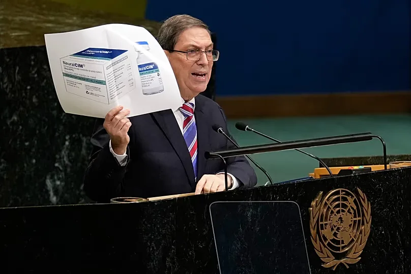 Cuban foreign minister Bruno Rodriguez Parrilla holds up a photo of a medication while speaking at United Nations headquarters. 28 October 2026. 