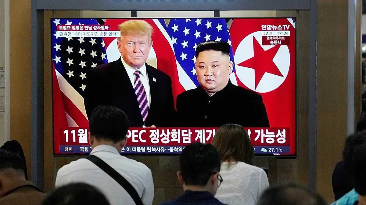 A TV screen shows a file image of North Korean leader Kim Jong Un and U.S. President Donald Trump during a news program at Seoul Railway Station in Seoul, South Korea.