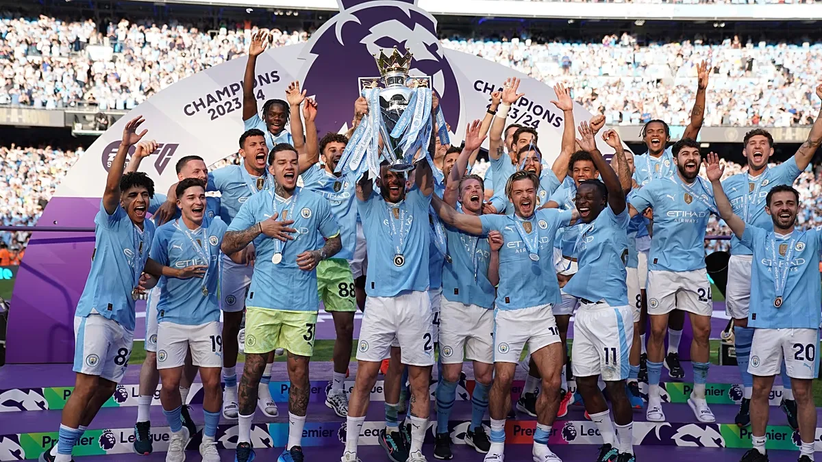 Manchester City players celebrate with the Premier League trophy after the English Premier League soccer match between Manchester City and West Ham United in Manchester.