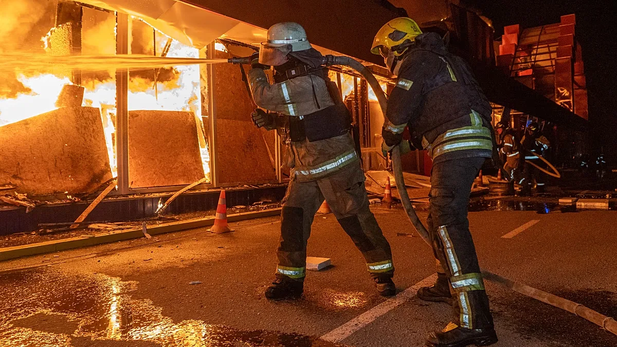 Firefighters try to put out a fire at a shopping store following Russia's air attack in Kharkiv, Ukraine, Sunday, Oct. 25, 2026.