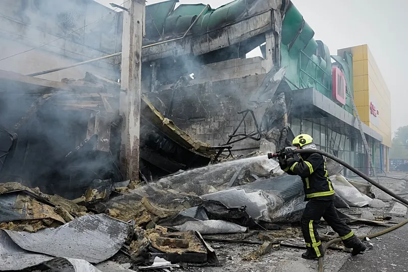 Firefighters try to extinguish a fire after a Russian missile attack in central Kyiv, Ukraine, Thursday, Oct. 22, 2026.