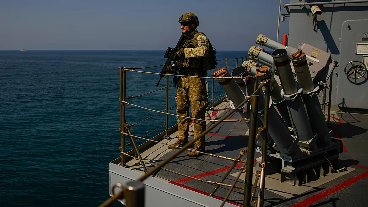 FILE: A Turkish army soldier stands guard on one of two ships sailing in the Mediterranean Sea, heading from the port of Mersin, Turkey, to the port of Beirut, 9 October 2024