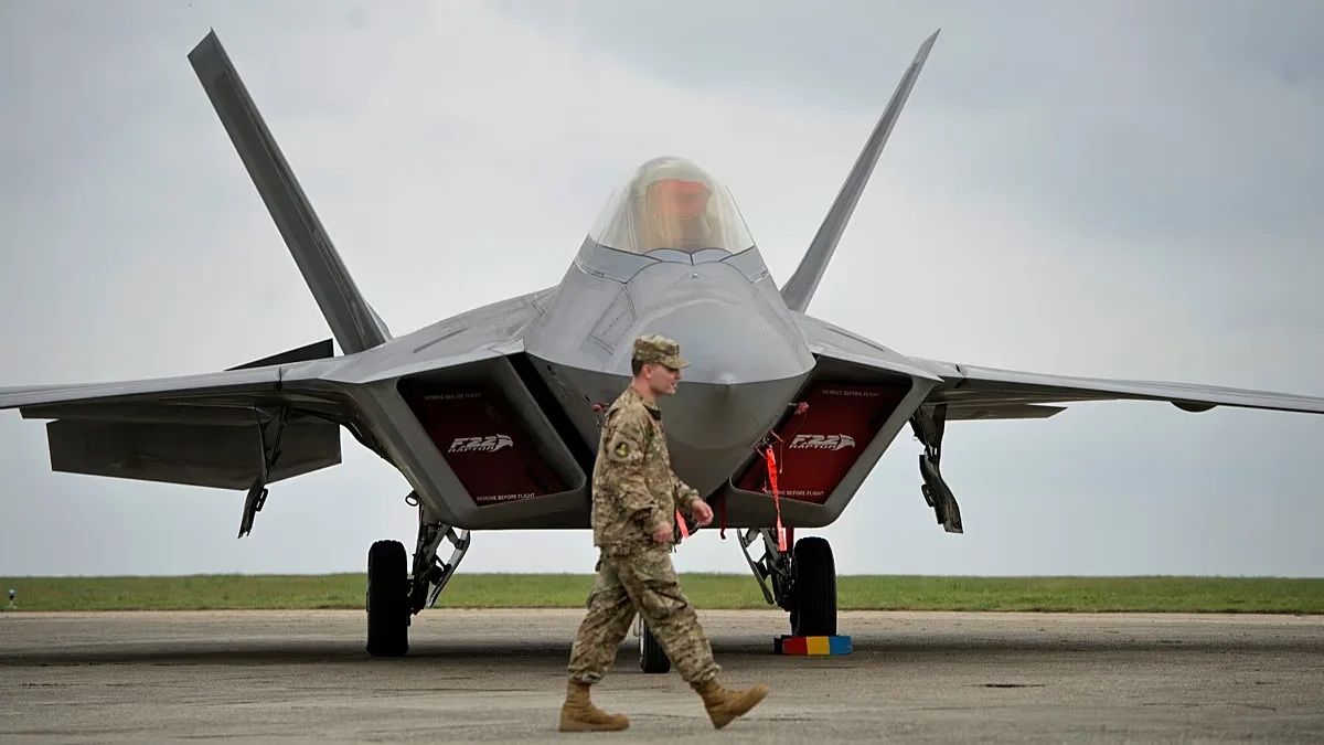 FILE: A US serviceman walks by a US Air Force F-22 Raptor fighter jet, 25 April 2015