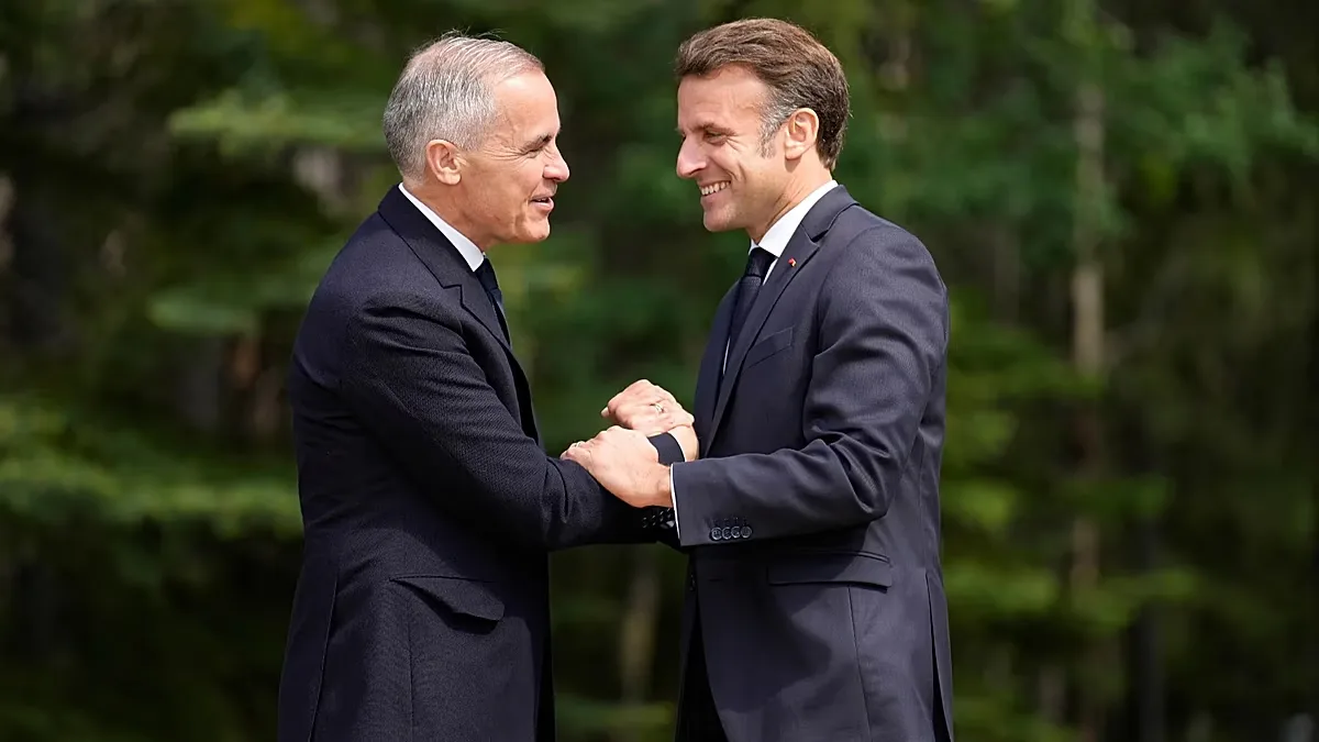 Mark Carney greets Emmanuel Macron at the official welcome for the G7 summit on 16 June 2025 in Kananaskis, Canada.