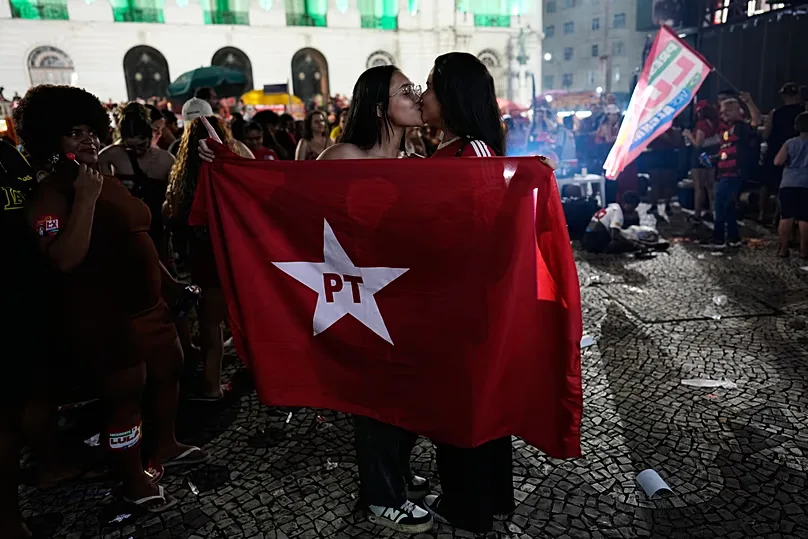 Supporters of President Lula da Silva, who is running for reelection, kiss as they react to partial presidential election results in Rio de Janeiro, Sunday, Oct. 4, 2026