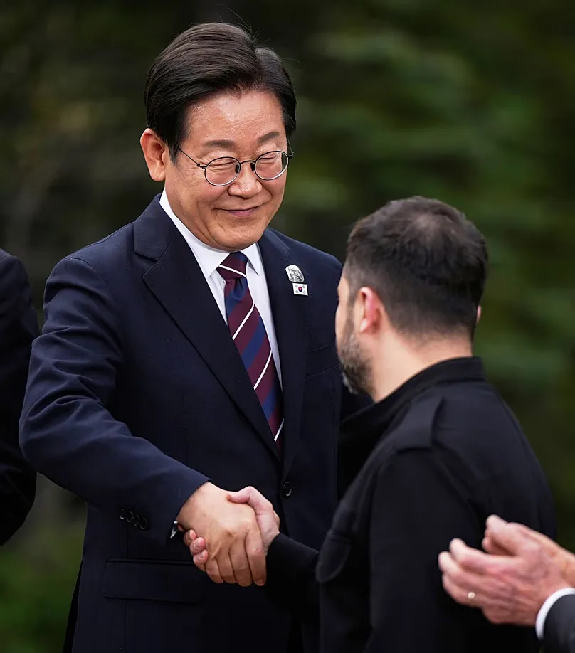 South Korean President Lee Jae-myung shakes hands with Ukraine's Volodymyr Zelensky ahead of a family photo during the G7 Summit in Kananaskis, Alberta, Tuesday, June 17, 2025