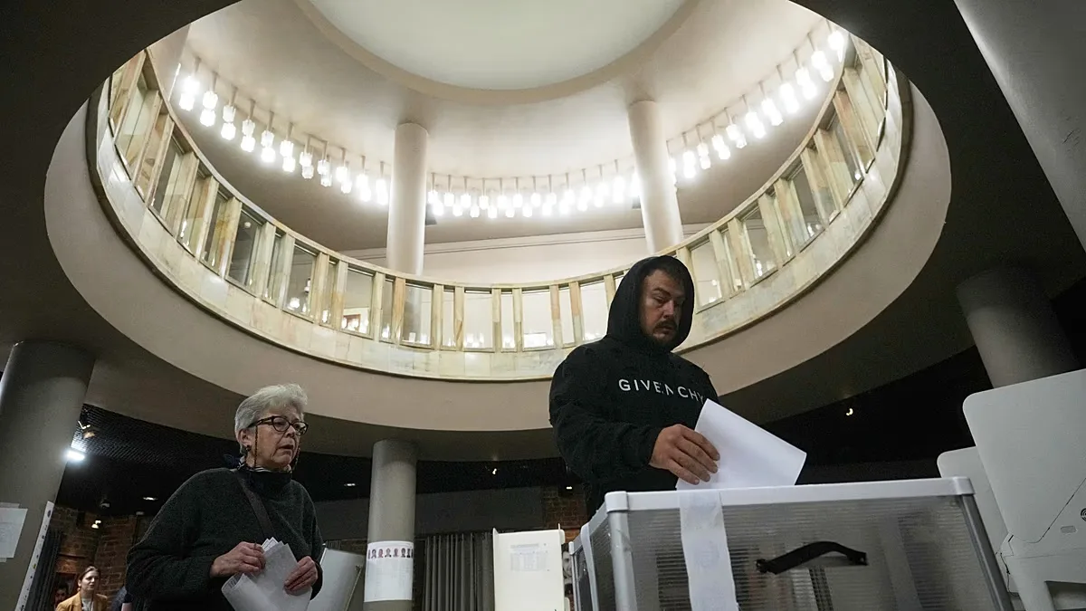 A voter casts a ballot in the parliamentary election in Moscow, Sunday, Sept. 20, 2026.