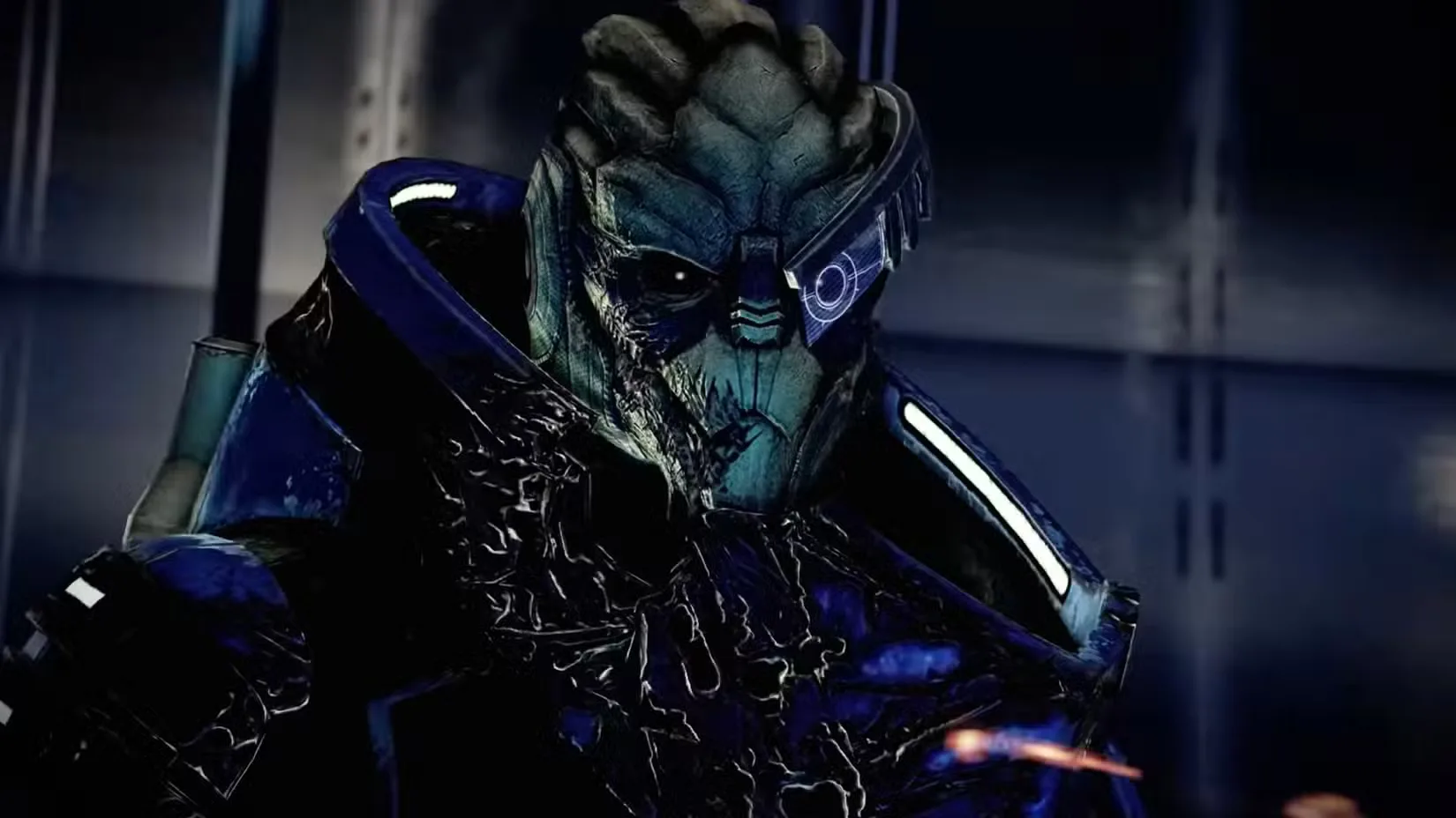 A close-up of Garrus, an alien from Mass Effect, wearing blue armor and a visor over one eye.