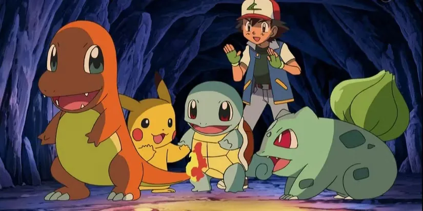 A black-haired anime boy (Ash), along with three smiling creatures (L-R Pikachu, Squirtle, Bulbasaur), huddle around the flaming tail of an orange creature (Charmander) in a dark cave.