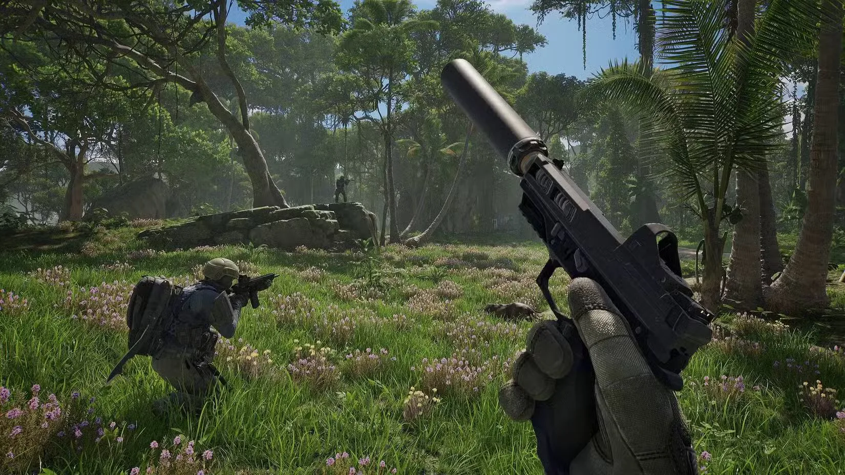 The player in PUBG: Black Budget holding a pistol with a silencer equipped, with another player crouched in front of them aiming down their assault rifle into a jungle.