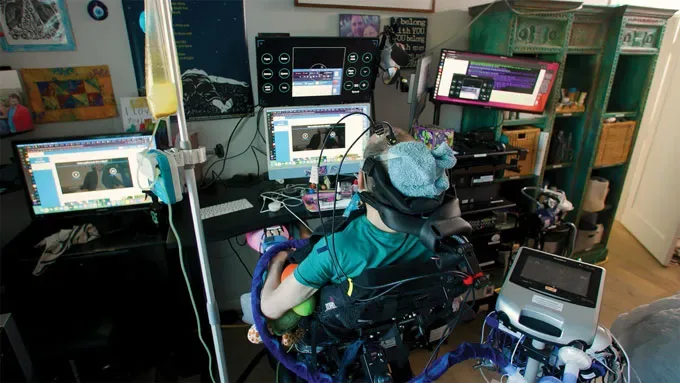 A photo of Casey Harrell sitting in front of multiple computer screens, plugged into his "Matrix"