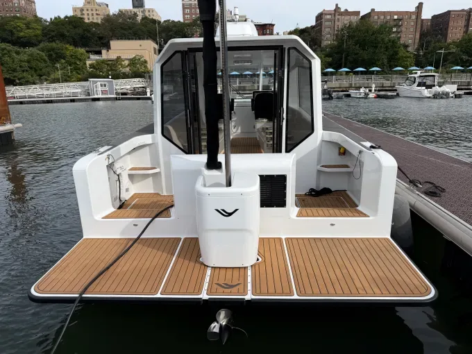 A hydrofoil ferry docked with its rear foil raised.